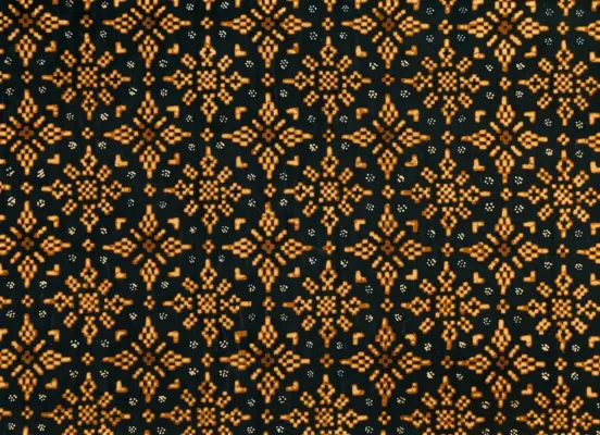Authentic Yogyakarta Batik Nitik Cakar Ayam motif composed of intricate geometric square dots in golden soga brown on a solid jet-black hand-dyed fabric