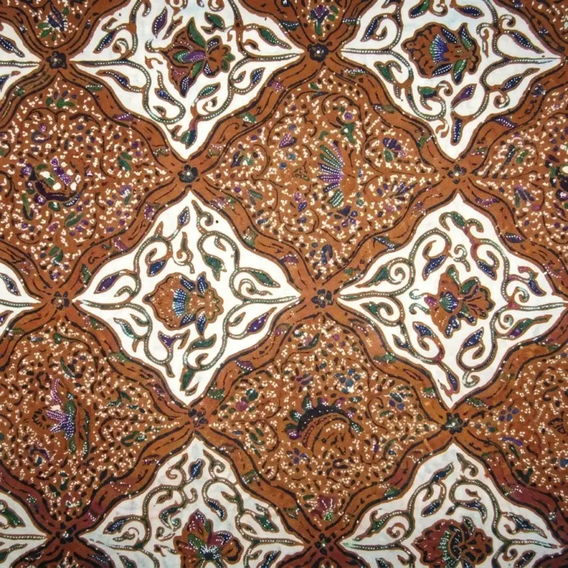 Close-up of authentic Sido Asih batik fabric showing repeating brown rhombus geometric patterns filled with traditional floral motifs.