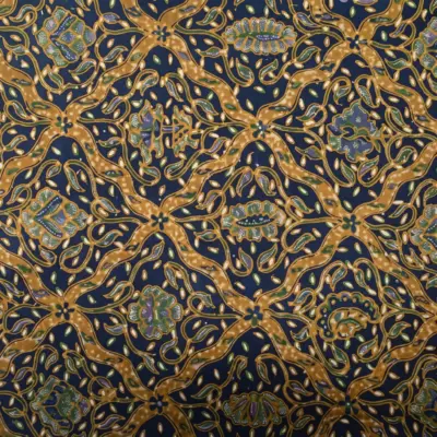 Close-up of the traditional Sido Luhur batik motif featuring authentic handmade geometric and floral patterns in sogan brown and indigo.