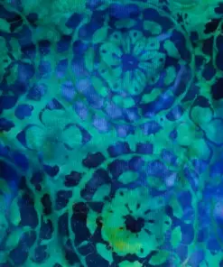 Repeating hand-stamped mandala floral pattern on deep ocean blue and emerald green 100% cotton batik fabric for quilting and apparel.