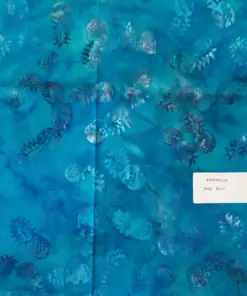 Deep blue authentic batik fabric displaying stamped tropical pineapple designs with subtle tonal variations and ocean-inspired water motifs.