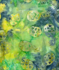 Sun-kissed green and yellow Pineapple Tropical batik fabric highlighting detailed pineapple stamps with an organic, hand-dyed texture.