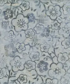 Close-up of light gray handmade Indonesian batik fabric featuring a delicate Jasmine floral pattern, perfect for quilting and sewing.