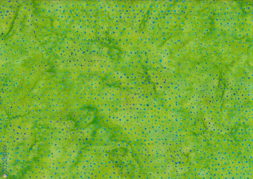 Bright lime green dotted batik fabric featuring vibrant blue speckles on 100% premium cotton, perfect for energetic, tropical sewing crafts