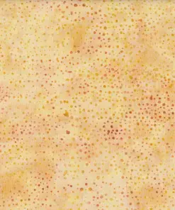 Close up of authentic orange yellow dotted batik fabric featuring a warm, sun-kissed speckled pattern on 100% premium cotton, ideal for bright sewing projects.