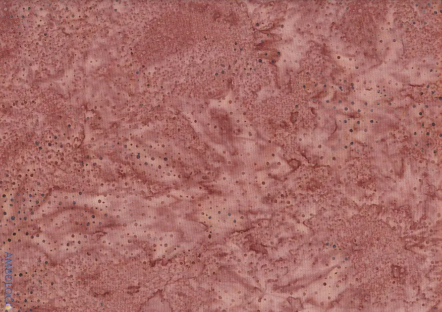 Textured rosy brown dotted batik fabric featuring an earthy, warm reddish-brown hue with dark speckled patterns on 100% premium cotton.