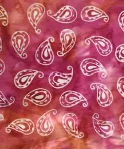 Bright orange and pink marbled authentic Indonesian paisley batik fabric, featuring a traditional repeating copper stamp motif.