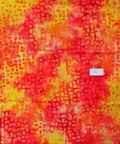 Artisan hand-dyed fire yellow batik fabric with small random geometric box patterns in red, orange, and yellow hues.