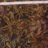 Coneflower Brown Floral Batik Fabric hand stamped on 100 percent combed cotton in earthy amber gold and mocha tones for quilting