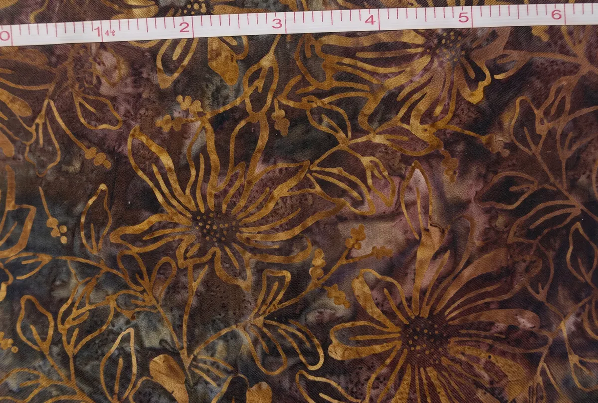 Coneflower Brown Floral Batik Fabric hand stamped on 100 percent combed cotton in earthy amber gold and mocha tones for quilting