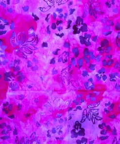 Text: Vibrant fuchsia passion pink and purple hand-stamped batik quilting fabric featuring marigold floral motifs, authentic Indonesian cotton.