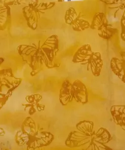 Authentic dark yellow butterfly tropical batik fabric with hand-stamped botanical textures.