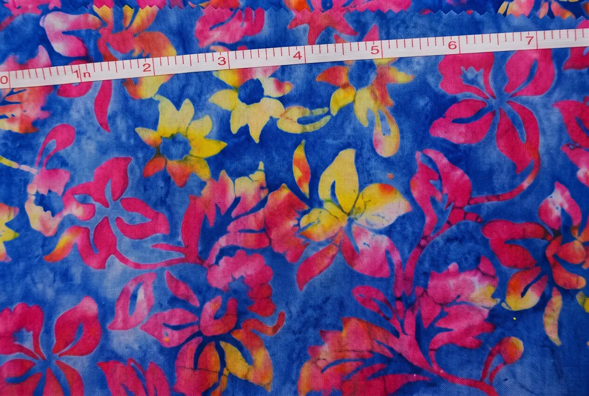 Vibrant ocean blue, fuchsia pink, and yellow Waikiki surf Hawaiian Plumeria Floral Batik Fabric made of premium cotton for summer dresses.