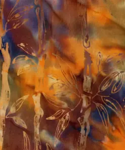 Monochromatic warm red-orange batik fabric with bold golden-yellow bamboo patterns.