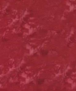 Close-up texture of red batik fabric by the yard showing Lush Island Cardinal, deep ruby garnet, and rosewood blush hand-dyed tie-dye marbling on 100% combed cotton.
