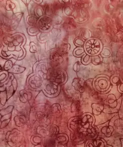 Close up of rustic crimson red hand-stamped Indonesian wild aster floral batik fabric for fall quilting.