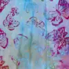Pastel violet and arctic blue tropical butterfly batik fabric for delicate quilting projects.