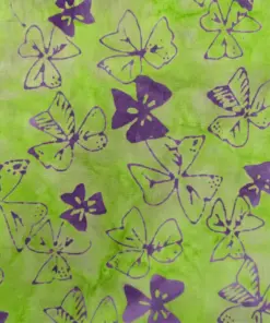 Vibrant spring meadow green and purple dogwood floral batik fabric crafted with traditional wax resist dyeing for vibrant quilts.