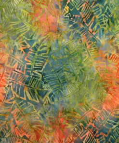 Close-up of hand-dyed green and orange tropical banana leaf batik fabric showing watercolor texture and hand-stamped botanical motifs.