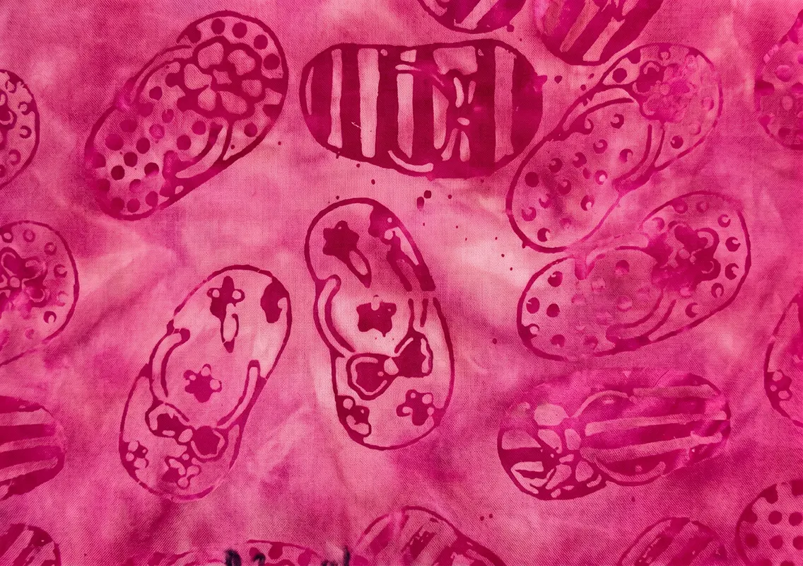 Vibrant pink monochrome hand-stamped sandal print handmade 100% cotton batik fabric.