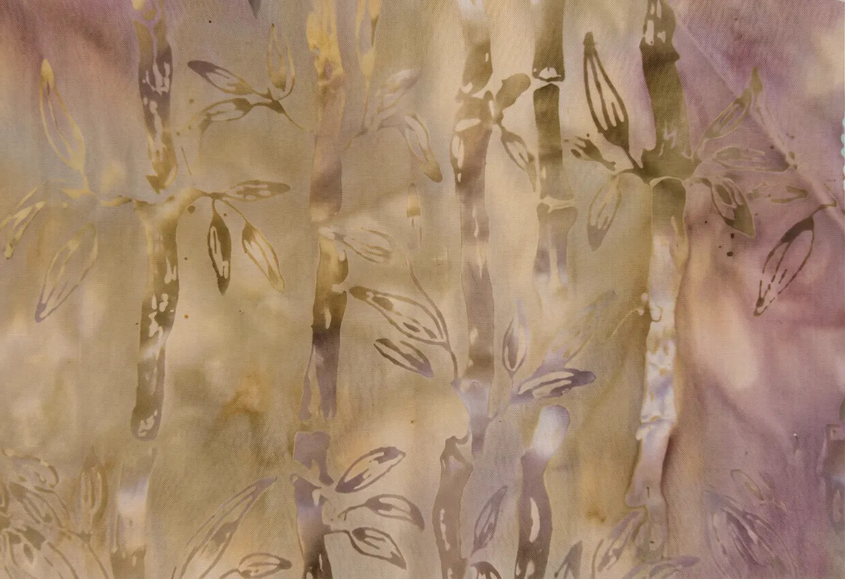 Soft mocha and lavender hand-dyed batik fabric featuring gilded bamboo stalks and leaves.